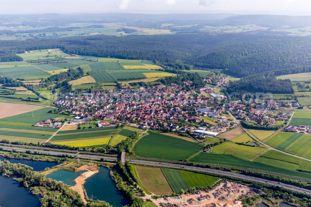 Aerial image Stettfeld - Village - view on the edge of agricultural fields and farmland in Stettfeld in the state Bavaria, Germany