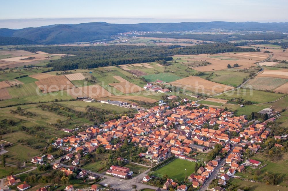 Uhrwiller from the bird's eye view: Village - view on the edge of agricultural fields and farmland in Uhrwiller in Grand Est, France