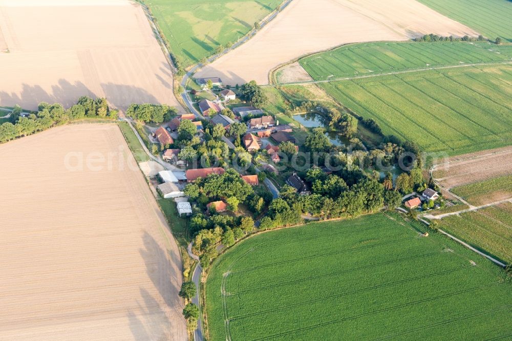 Addenstorf from the bird's eye view: Agricultural land and field borders surround the settlement area of the village in Addenstorf in the state Lower Saxony, Germany