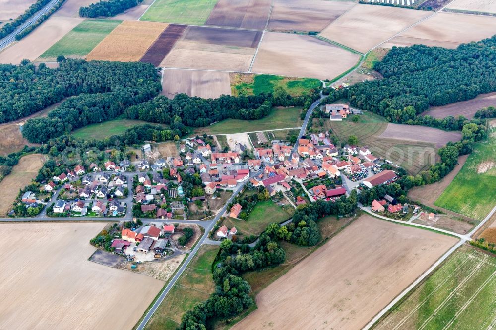 Atzhausen from above - Agricultural land and field borders surround the settlement area of the village in Atzhausen in the state Bavaria, Germany