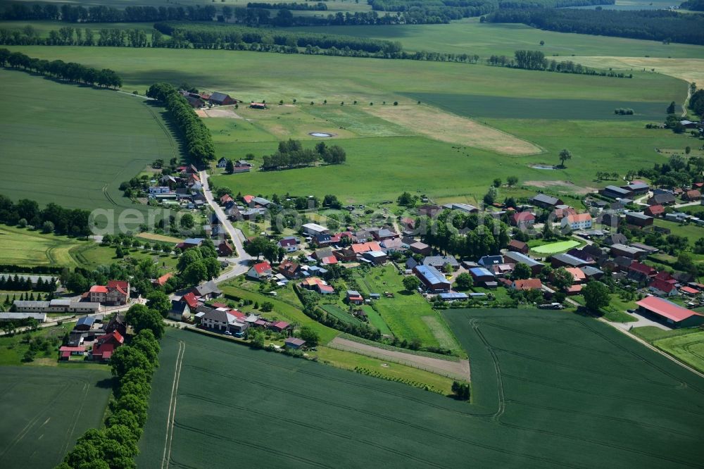 Benzin from above - Agricultural land and field borders surround the settlement area of the village in Benzin in the state Mecklenburg - Western Pomerania, Germany