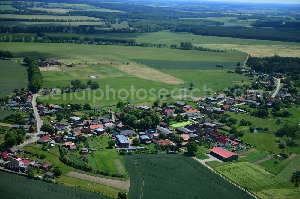 Benzin from the bird's eye view: Agricultural land and field borders surround the settlement area of the village in Benzin in the state Mecklenburg - Western Pomerania, Germany