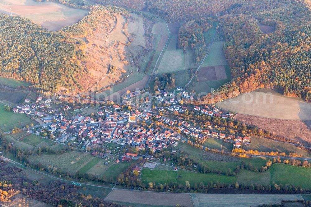 Binsfeld from above - Agricultural land and field borders surround the settlement area of the village in Binsfeld in the state Bavaria, Germany