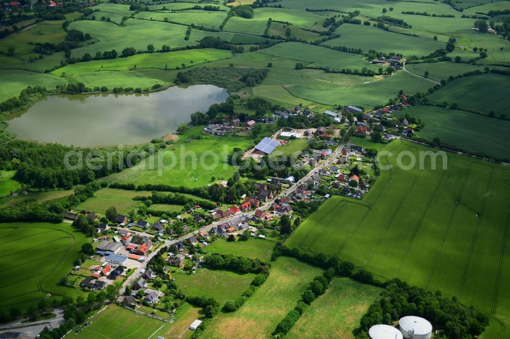 Bujendorf from the bird's eye view: Agricultural land and field borders surround the settlement area of the village in Bujendorf in the state Schleswig-Holstein, Germany