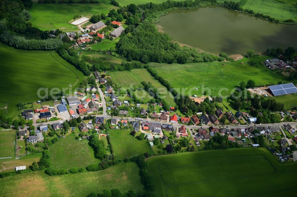 Aerial image Bujendorf - Agricultural land and field borders surround the settlement area of the village in Bujendorf in the state Schleswig-Holstein, Germany