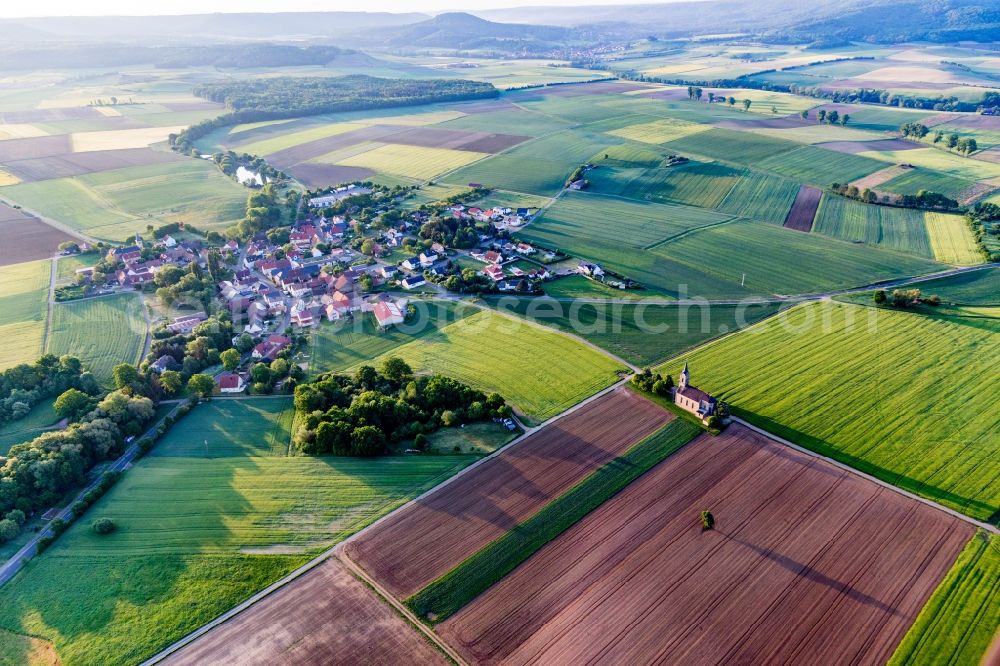 Aerial image Dingolshausen - Agricultural land and field borders surround the settlement area of the village in Dingolshausen in the state Bavaria, Germany