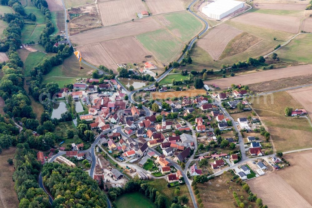 Aerial photograph Füttersee - Agricultural land and field borders surround the settlement area of the village in Fuettersee in the state Bavaria, Germany