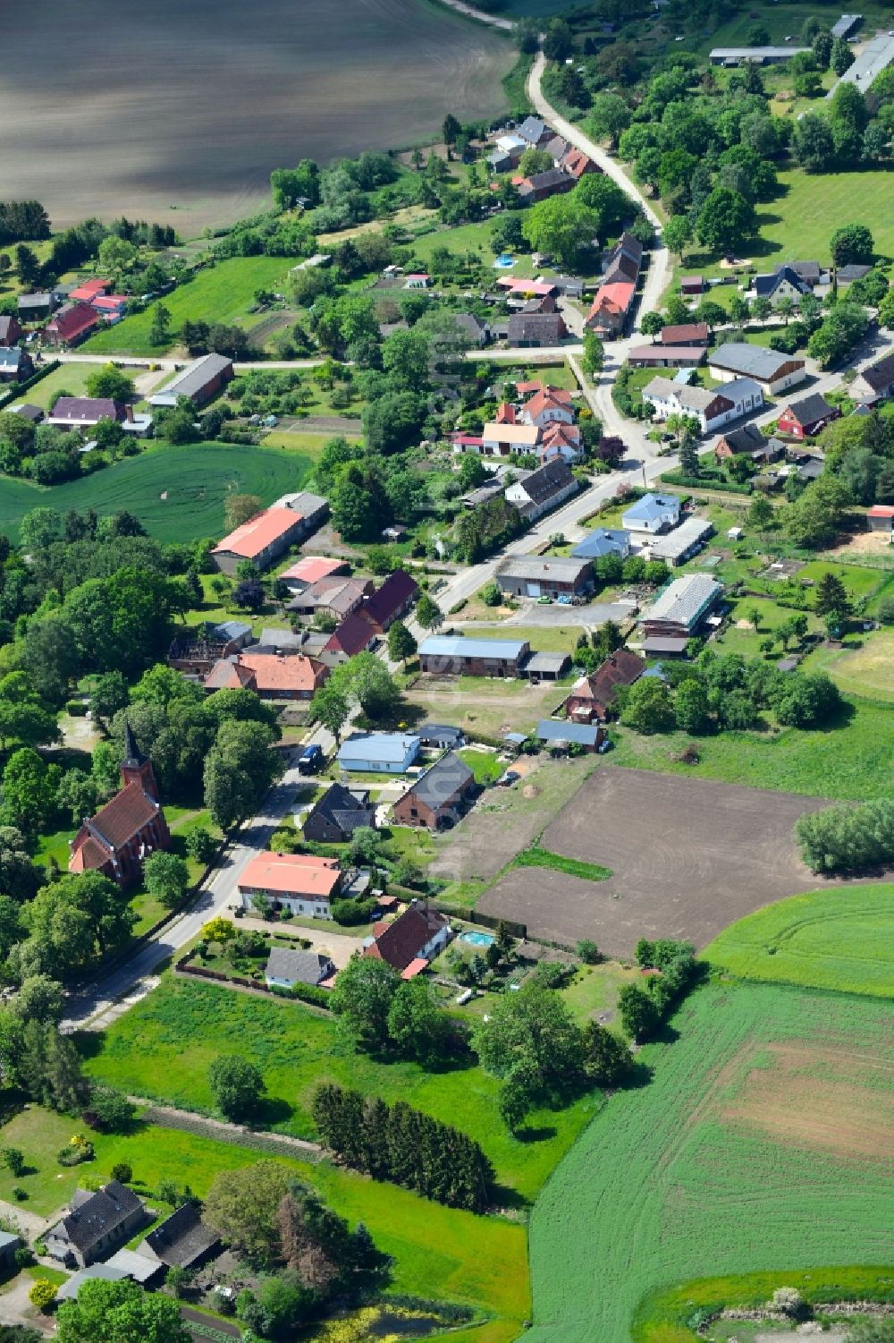 Granzin from above - Agricultural land and field borders surround the settlement area of the village in Granzin in the state Mecklenburg - Western Pomerania, Germany