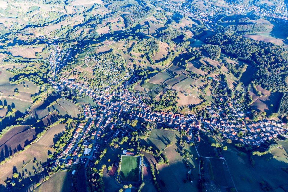 Gronau from the bird's eye view: Agricultural land and field borders surround the settlement area of the village in Gronau in the state Hesse, Germany