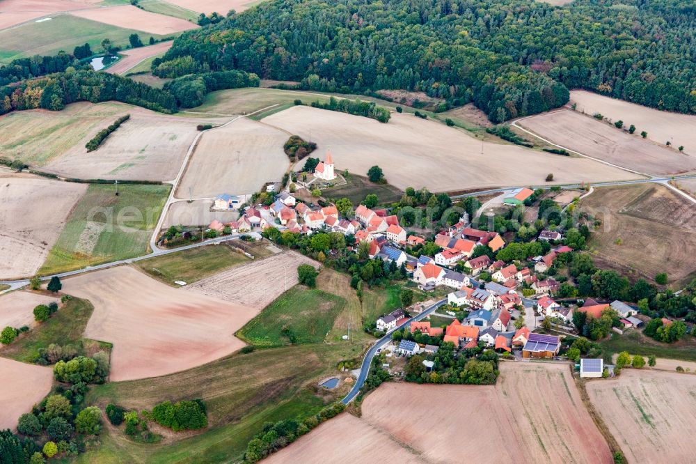 Aerial image Großbirkach - Agricultural land and field borders surround the settlement area of the village in Grossbirkach in the state Bavaria, Germany