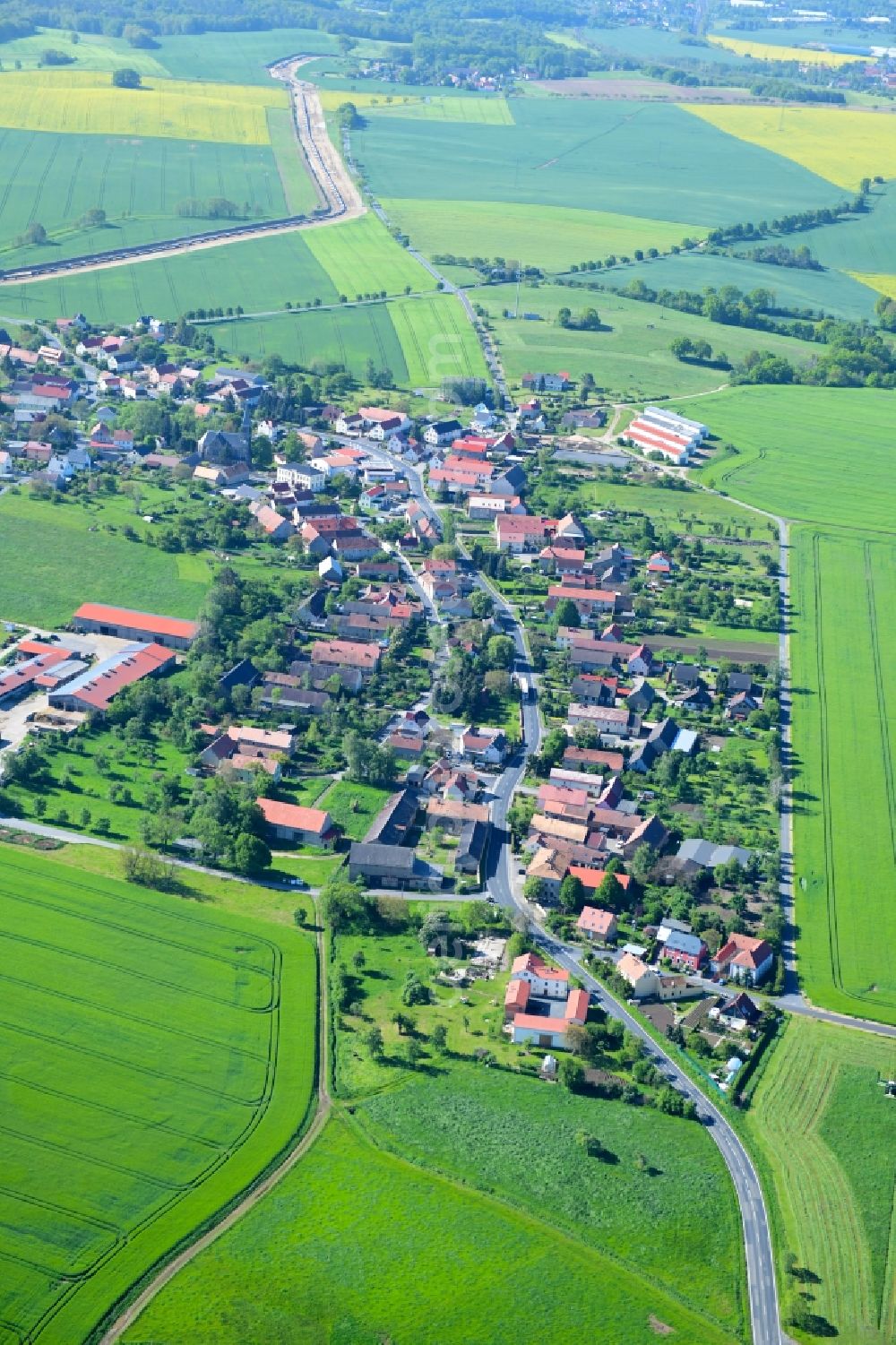 Großdobritz from above - Agricultural land and field borders surround the settlement area of the village in Grossdobritz in the state Saxony, Germany