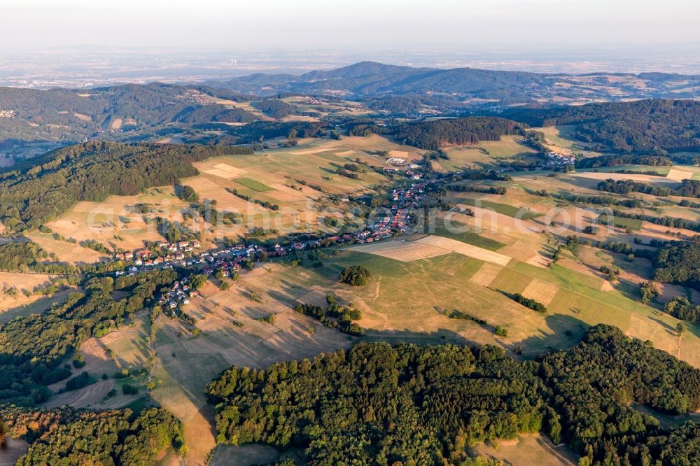 Gumpen from above - Agricultural land and field borders surround the settlement area of the village in Gumpen in the state Hesse, Germany