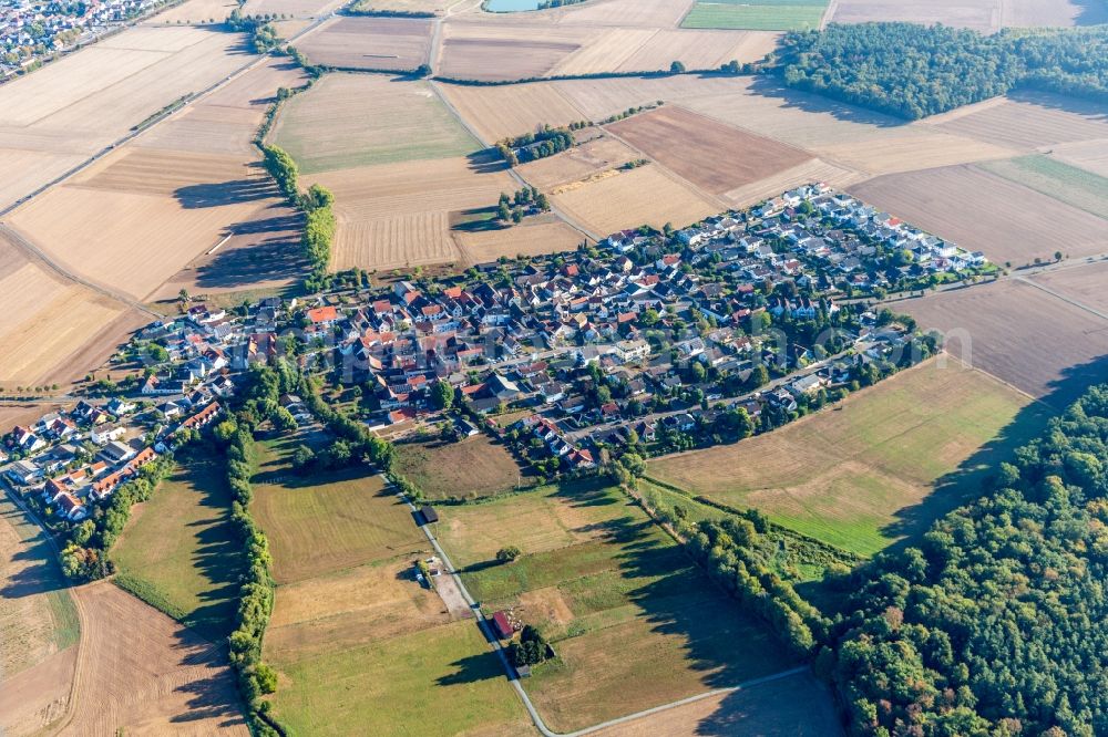 Harpertshausen from above - Agricultural land and field borders surround the settlement area of the village in Harpertshausen in the state Hesse, Germany