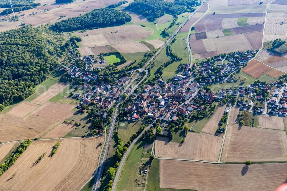 Hirschlanden from above - Agricultural land and field borders surround the settlement area of the village in Hirschlanden in the state Baden-Wurttemberg, Germany