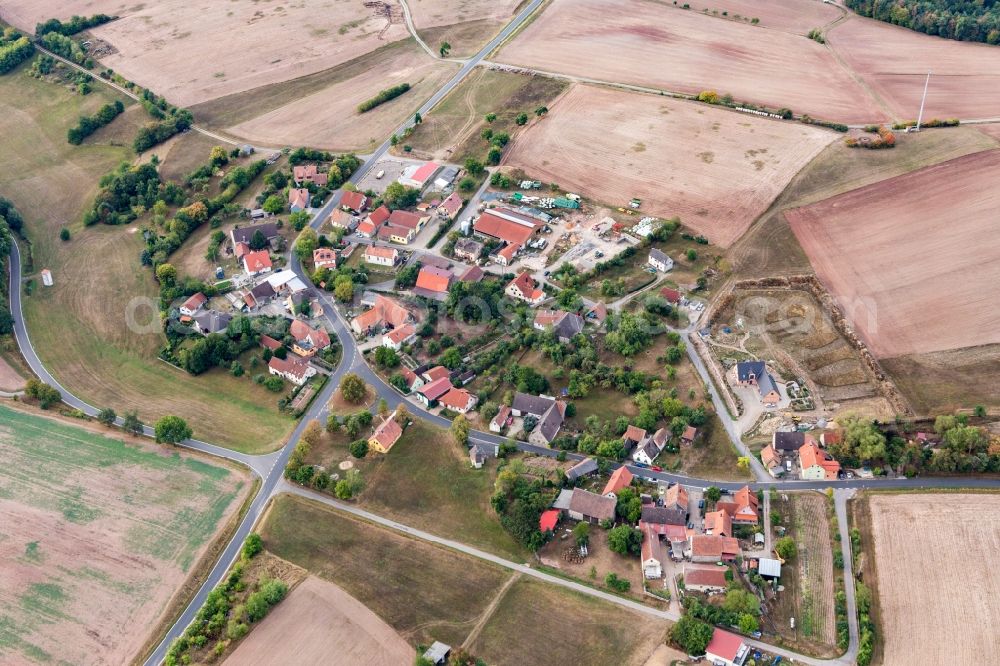 Aerial image Ilmenau - Agricultural land and field borders surround the settlement area of the village in Ilmenau in the state Bavaria, Germany