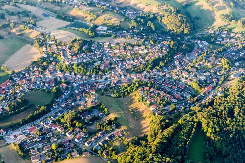 Aerial photograph Kirschhausen - Agricultural land and field borders surround the settlement area of the village in Kirschhausen in the state Hesse, Germany