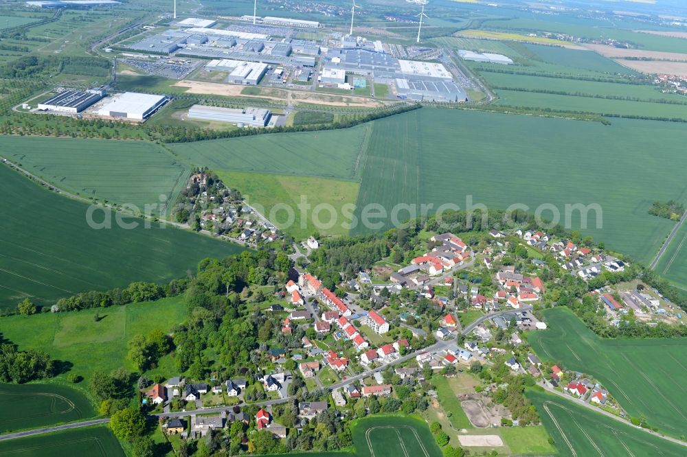 Merkwitz from above - Agricultural land and field borders surround the settlement area of the village in Merkwitz in the state Saxony, Germany