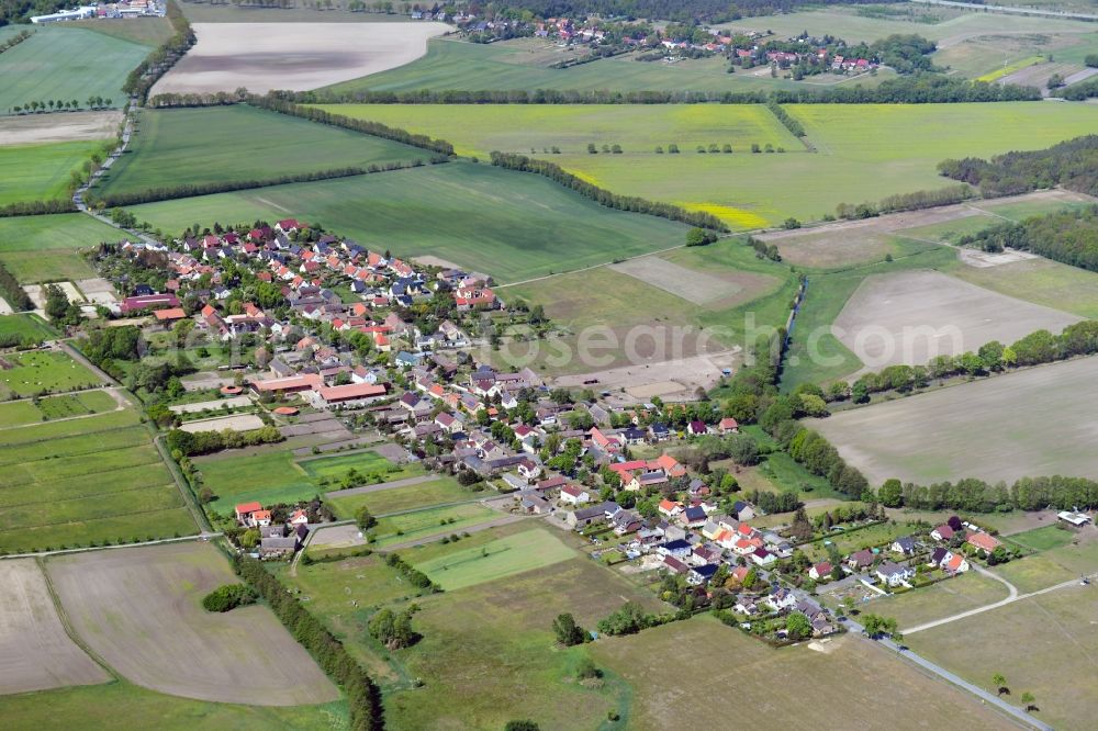 Nudow from above - Agricultural land and field borders surround the settlement area of the village in Nudow in the state Brandenburg, Germany