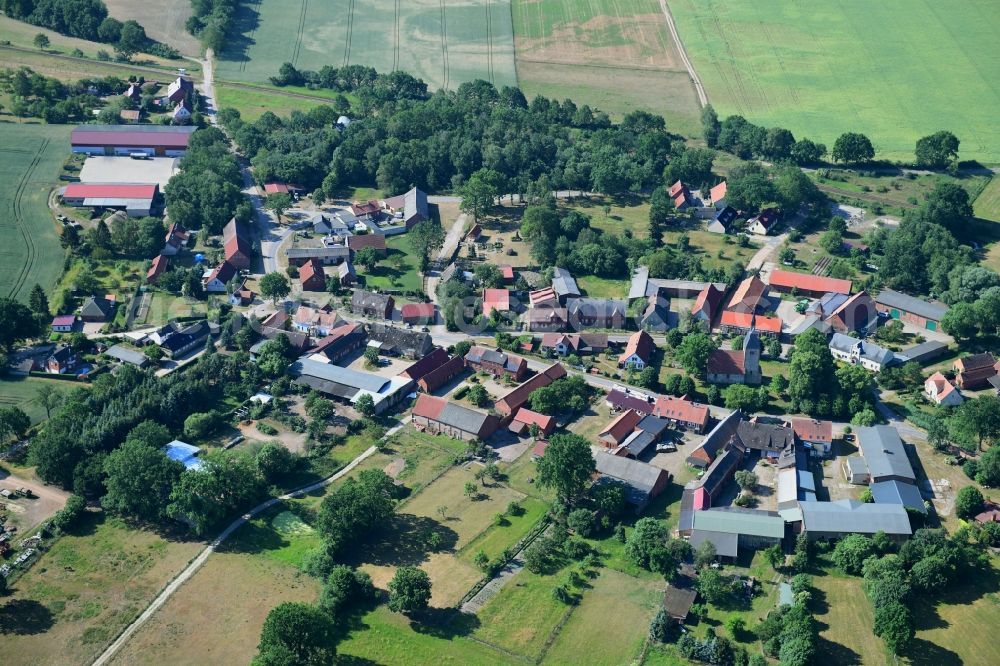 Aerial image Sarnow - Agricultural land and field borders surround the settlement area of the village in Sarnow in the state Brandenburg, Germany