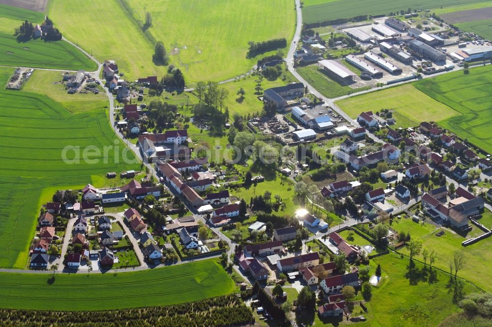 Welxande from above - Agricultural land and field borders surround the settlement area of the village in Welxande in the state Saxony, Germany