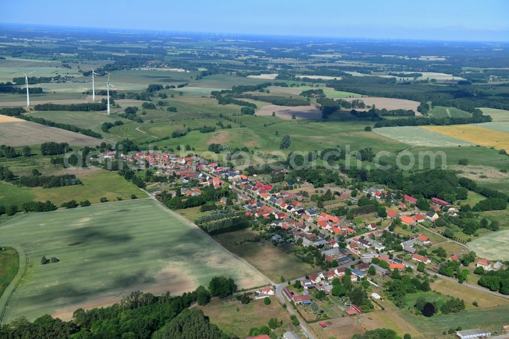 Aerial photograph Wutike - Agricultural land and field borders surround the settlement area of the village in Wutike in the state Brandenburg, Germany