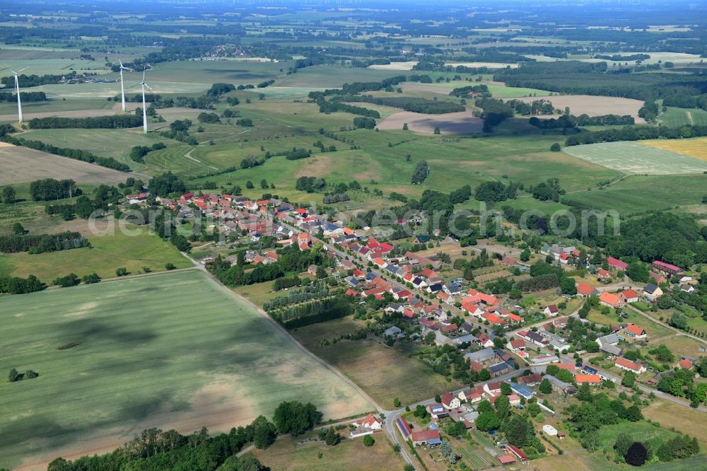 Wutike from above - Agricultural land and field borders surround the settlement area of the village in Wutike in the state Brandenburg, Germany