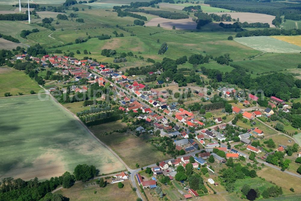 Wutike from the bird's eye view: Agricultural land and field borders surround the settlement area of the village in Wutike in the state Brandenburg, Germany