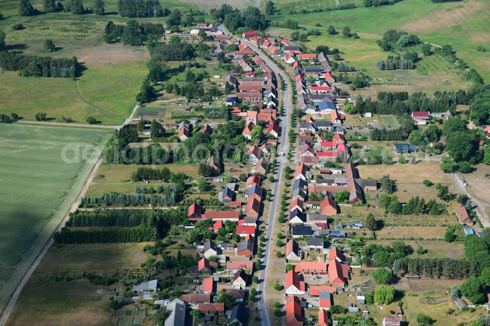 Aerial image Wutike - Agricultural land and field borders surround the settlement area of the village in Wutike in the state Brandenburg, Germany