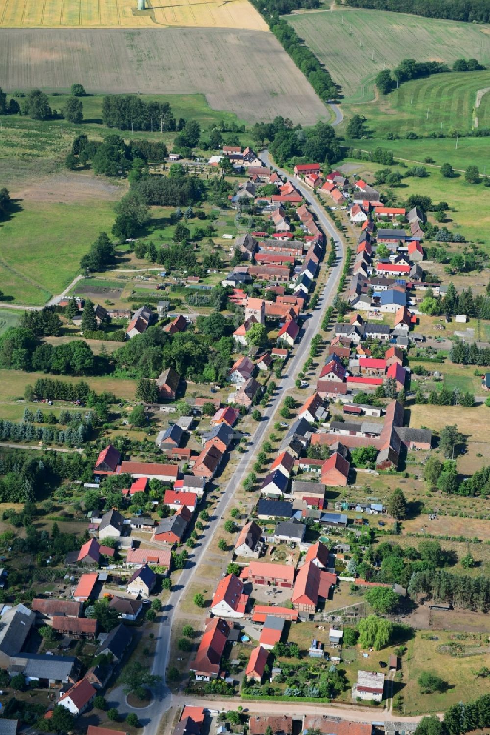 Aerial photograph Wutike - Agricultural land and field borders surround the settlement area of the village in Wutike in the state Brandenburg, Germany