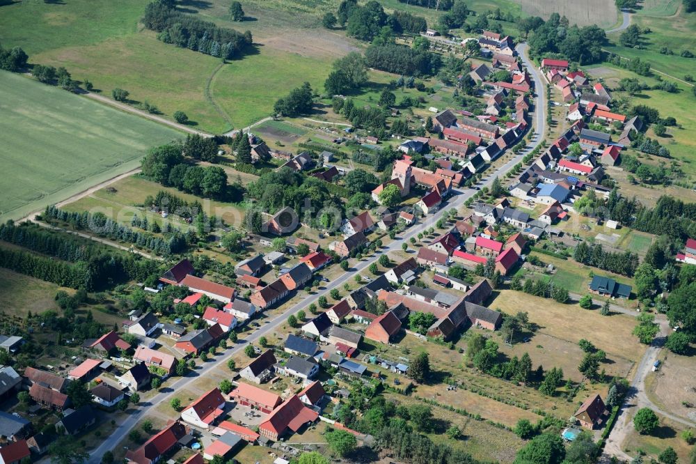 Aerial image Wutike - Agricultural land and field borders surround the settlement area of the village in Wutike in the state Brandenburg, Germany