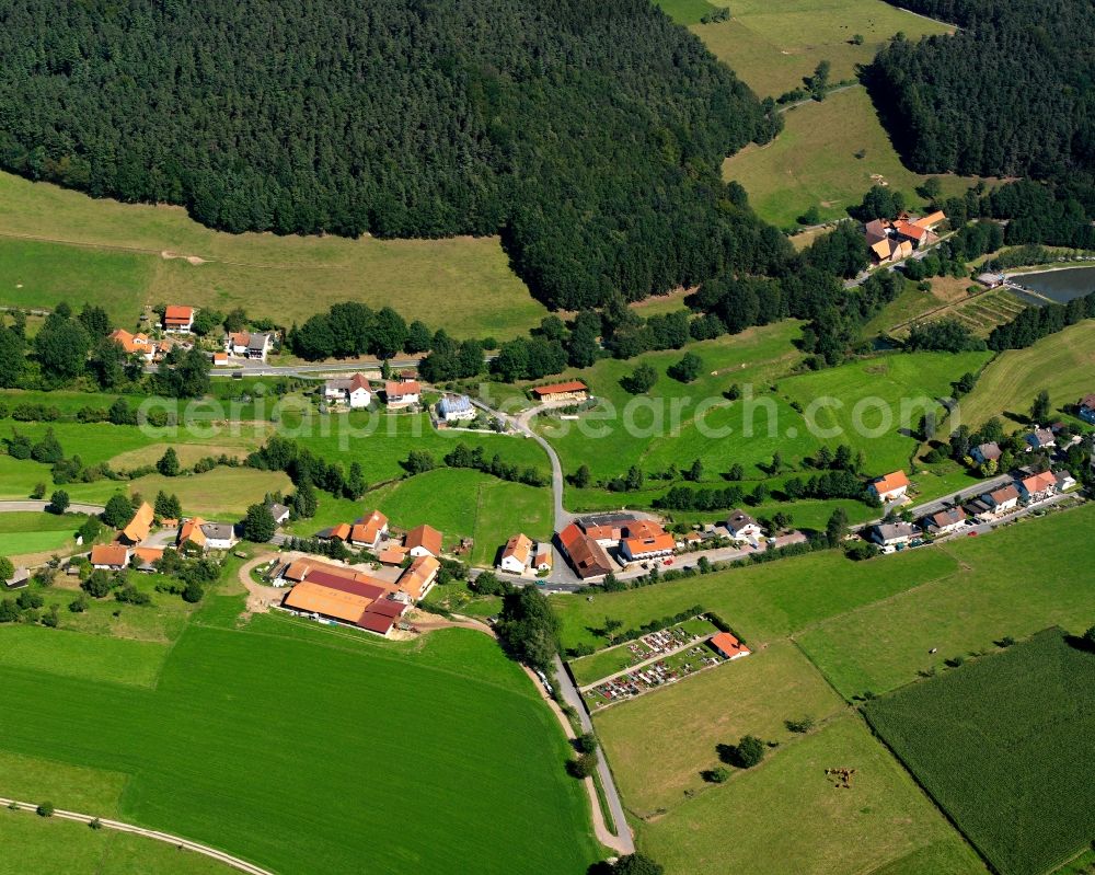 Hüttenthal from the bird's eye view: Village - view on the edge of forested areas in Hüttenthal in the state Hesse, Germany