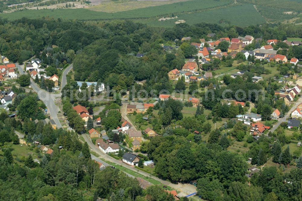 Kostebrau from the bird's eye view: Village - view on the edge of forested areas in Kostebrau in the state Brandenburg, Germany