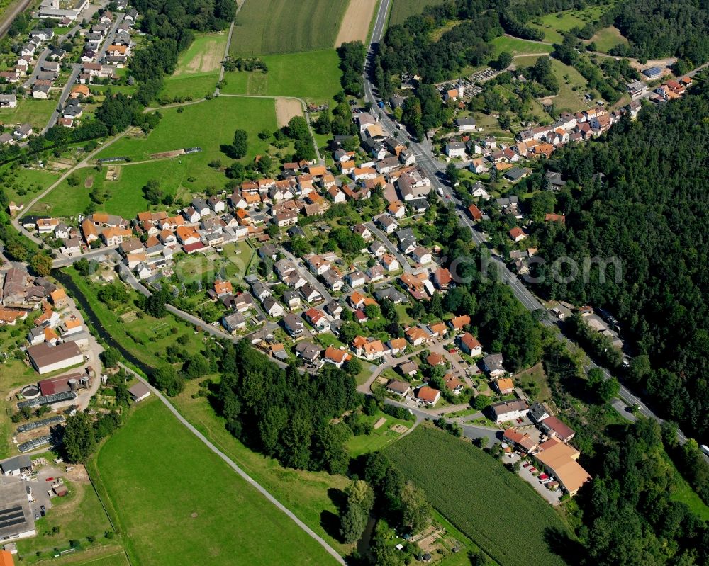 Mümling-Grumbach from the bird's eye view: Village - view on the edge of forested areas in Mümling-Grumbach in the state Hesse, Germany