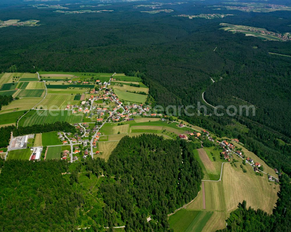 Neuweiler from the bird's eye view: Village - view on the edge of forested areas in Neuweiler in the state Baden-Wuerttemberg, Germany