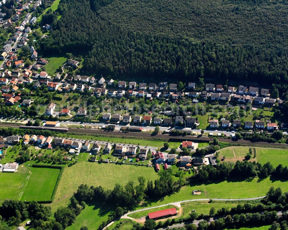 Zell from the bird's eye view: Village - view on the edge of forested areas in Zell in the state Hesse, Germany