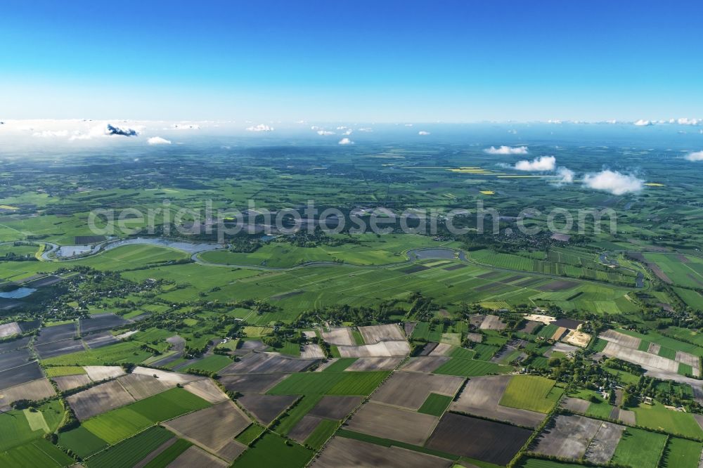 Blumenthal from the bird's eye view: Agricultural land and field boundaries surround the settlement area of the village in Blumenthal in the state Lower Saxony, Germany