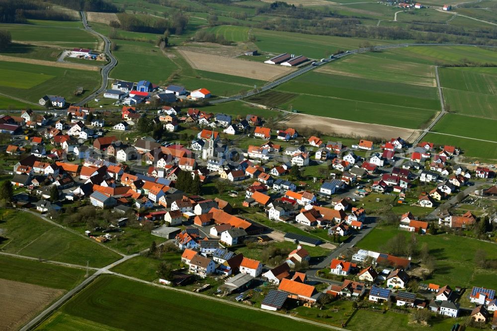 Thalau from above - Agricultural land and field borders surround the settlement area of the village in Thalau in the state Hesse, Germany