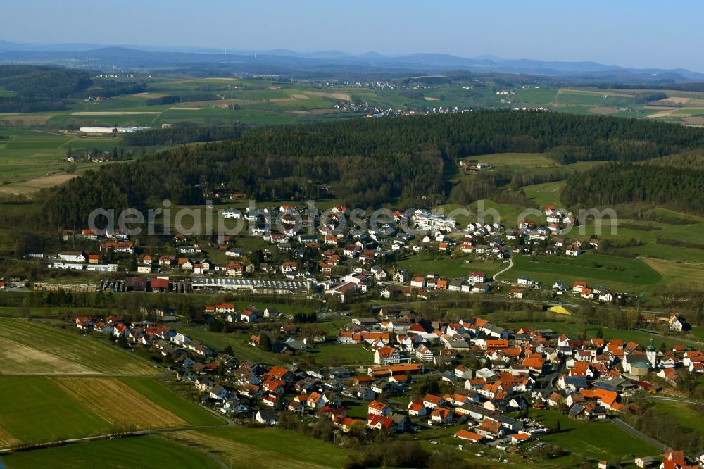 Thalau from above - Agricultural land and field borders surround the settlement area of the village in Thalau in the state Hesse, Germany