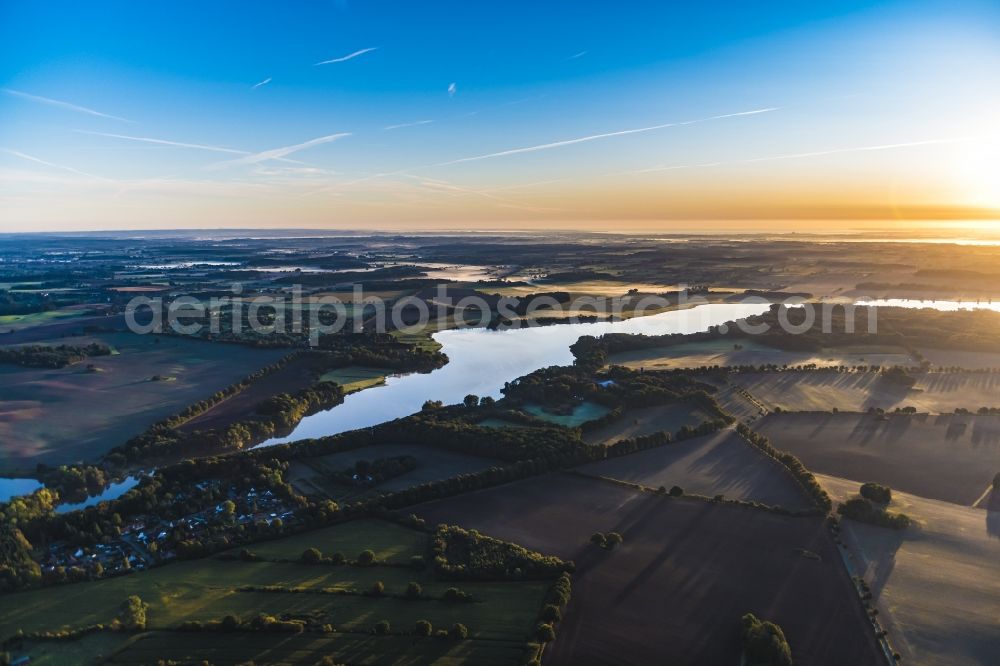 Aerial photograph Wardersee - Village view of the lake shore areas des Wardersee in Wardersee in sunrise in the state Schleswig-Holstein, Germany