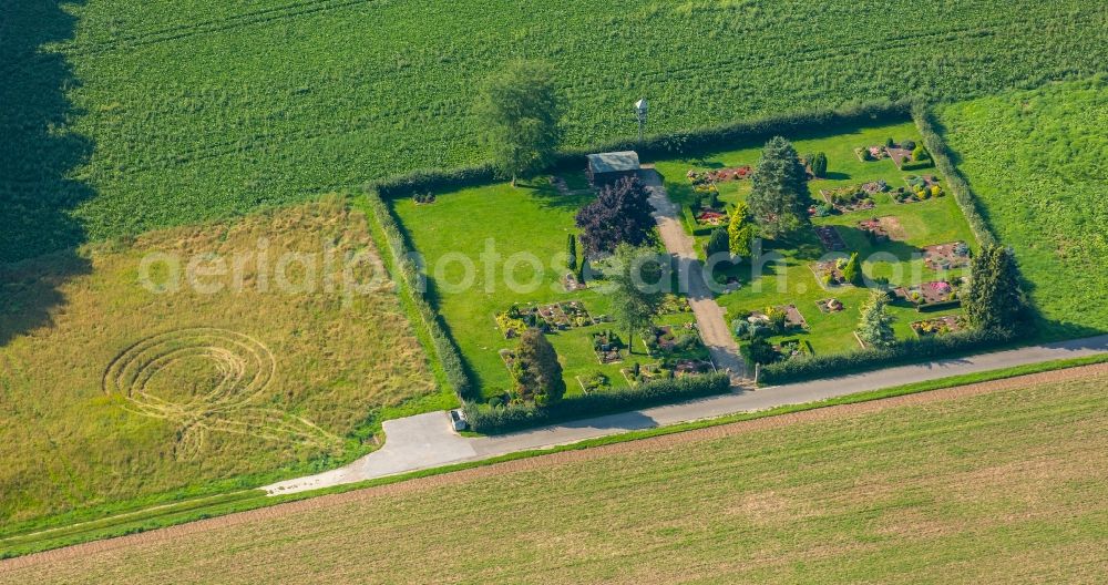 Bünde from above - Village cemetery in Buende in the state of North Rhine-Westphalia. The small cemetery is located on a field path