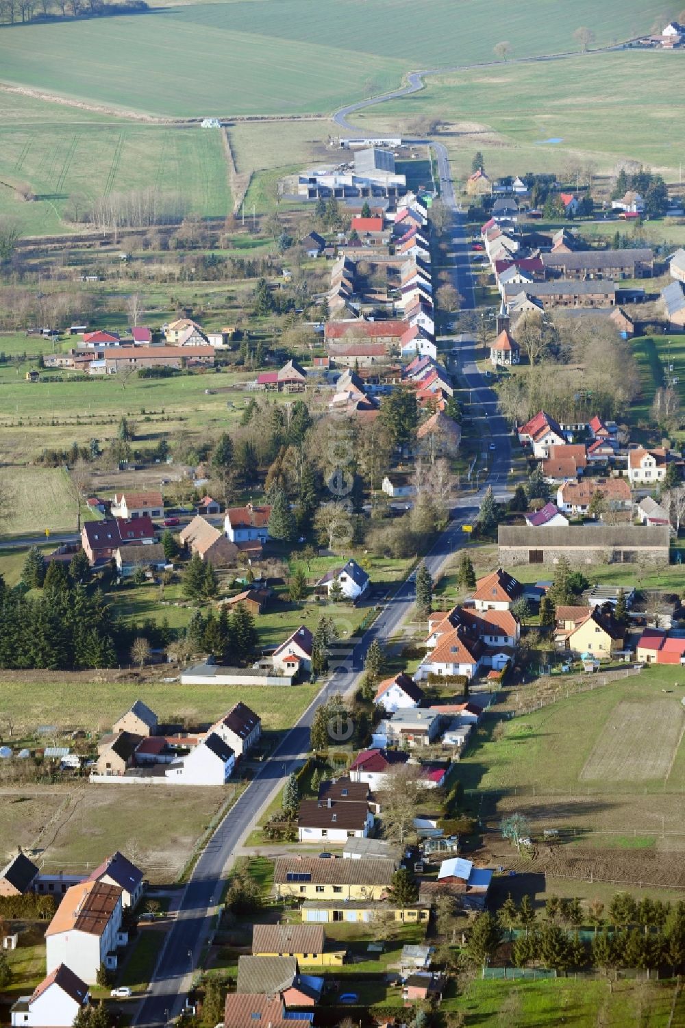 Altlüdersdorf from above - Agricultural land and field borders surround the settlement area of the village in Altluedersdorf in the state Brandenburg, Germany