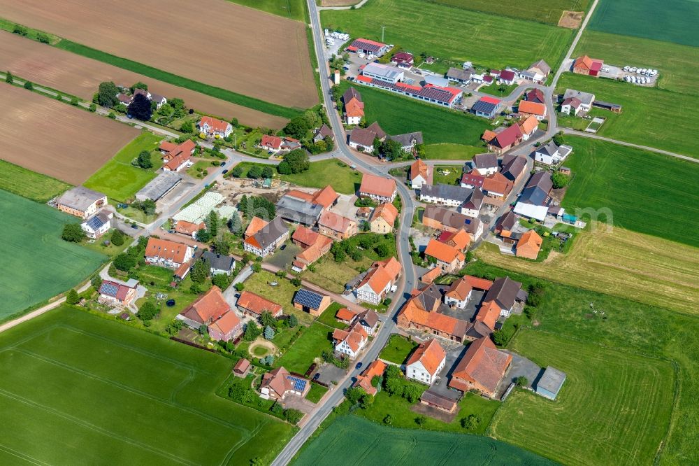 Aerial photograph Ammenhausen - Agricultural land and field borders surround the settlement area of the village in Ammenhausen in the state Hesse, Germany