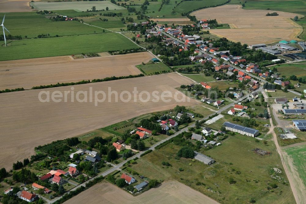 Barenthin from above - Agricultural land and field borders surround the settlement area of the village in Barenthin in the state Brandenburg, Germany