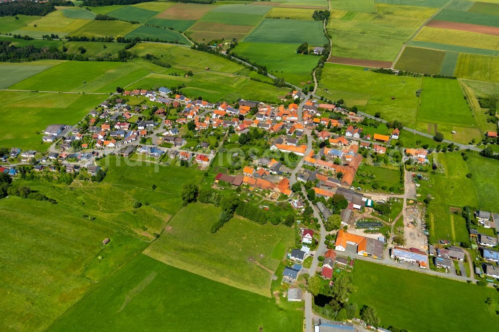 Aerial image Basdorf - Agricultural land and field borders surround the settlement area of the village in Basdorf in the state Hesse, Germany