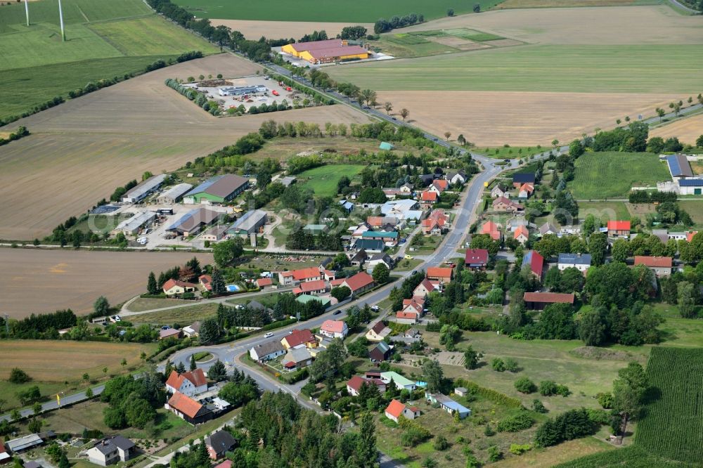 Bückwitz from above - Agricultural land and field borders surround the settlement area of the village in Bueckwitz in the state Brandenburg, Germany