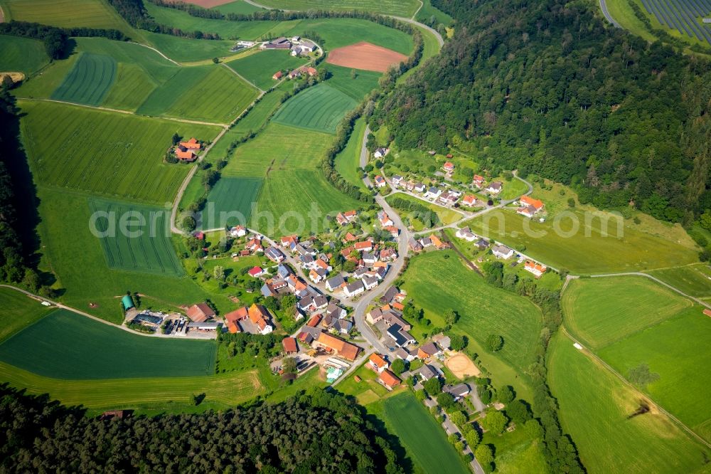 Braunsen from above - Agricultural land and field borders surround the settlement area of the village in Braunsen in the state Hesse, Germany