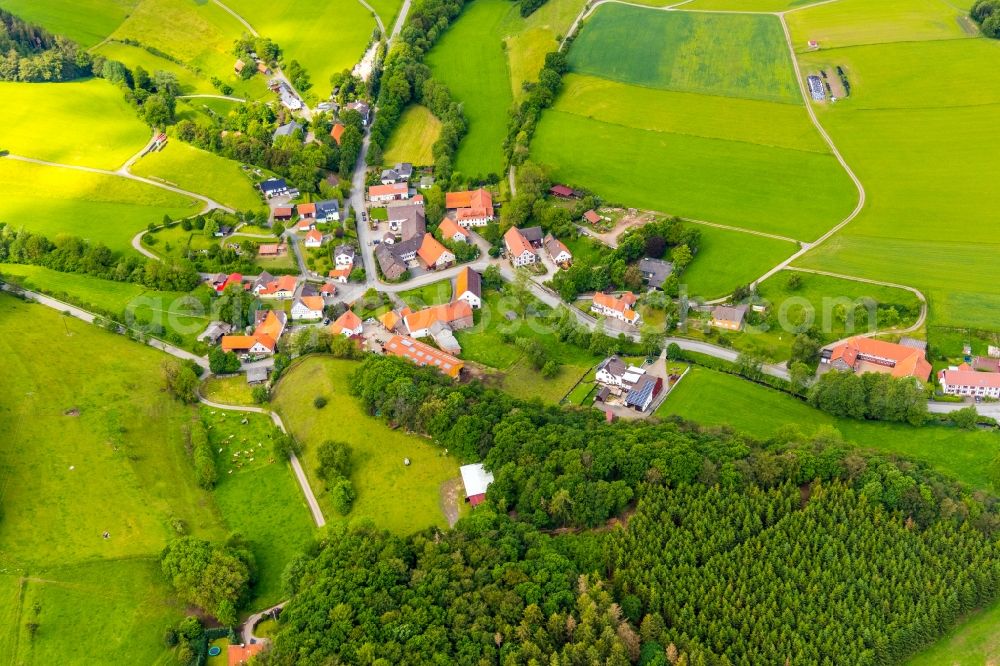 Deisfeld from above - Agricultural land and field borders surround the settlement area of the village in Deisfeld in the state Hesse, Germany