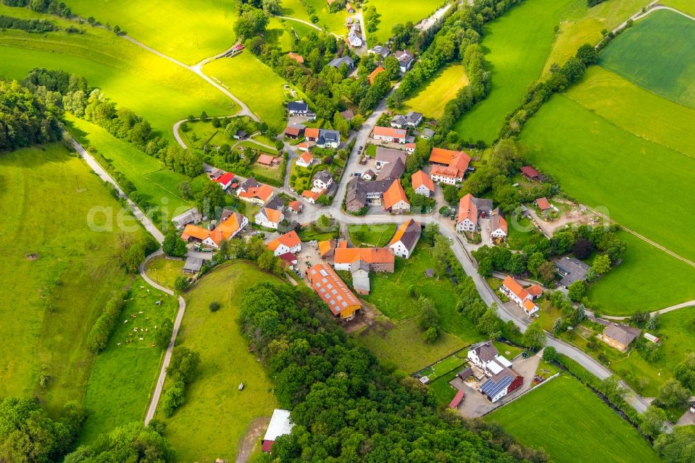 Deisfeld from the bird's eye view: Agricultural land and field borders surround the settlement area of the village in Deisfeld in the state Hesse, Germany