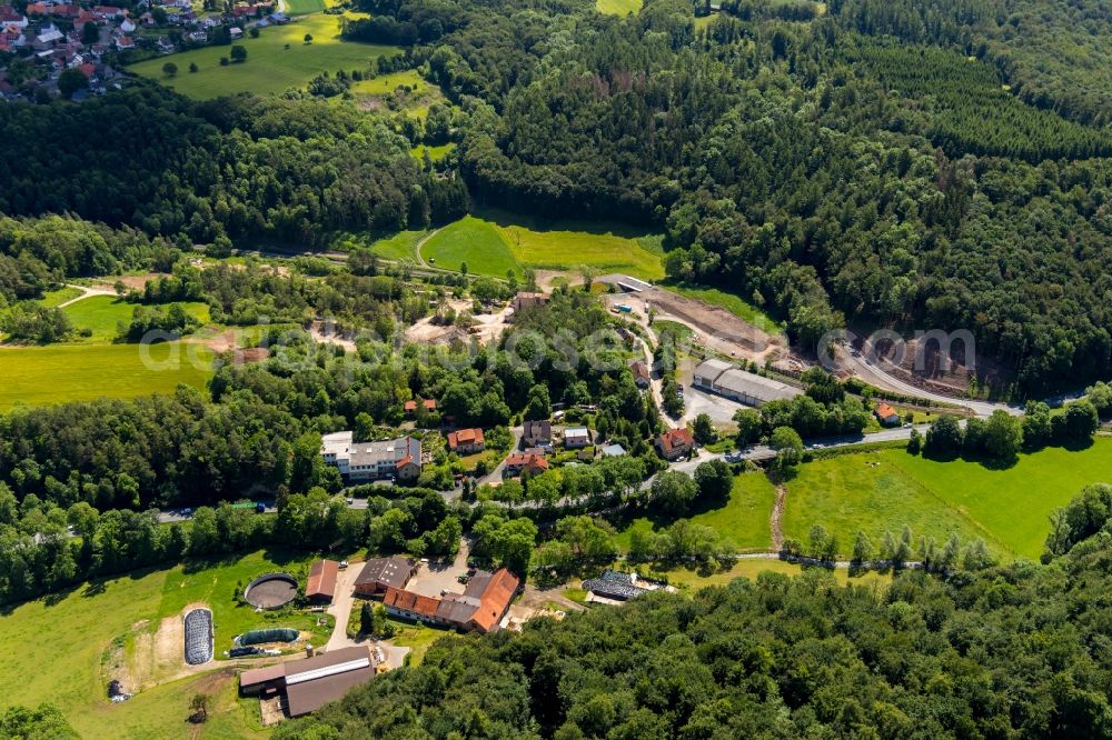 Dorfitter from above - Agricultural land and field borders surround the settlement area of the village in Dorfitter in the state Hesse, Germany