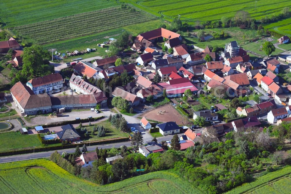 Aerial image Drebsdorf - Agricultural land and field borders surround the settlement area of the village in Drebsdorf in the state Saxony-Anhalt, Germany